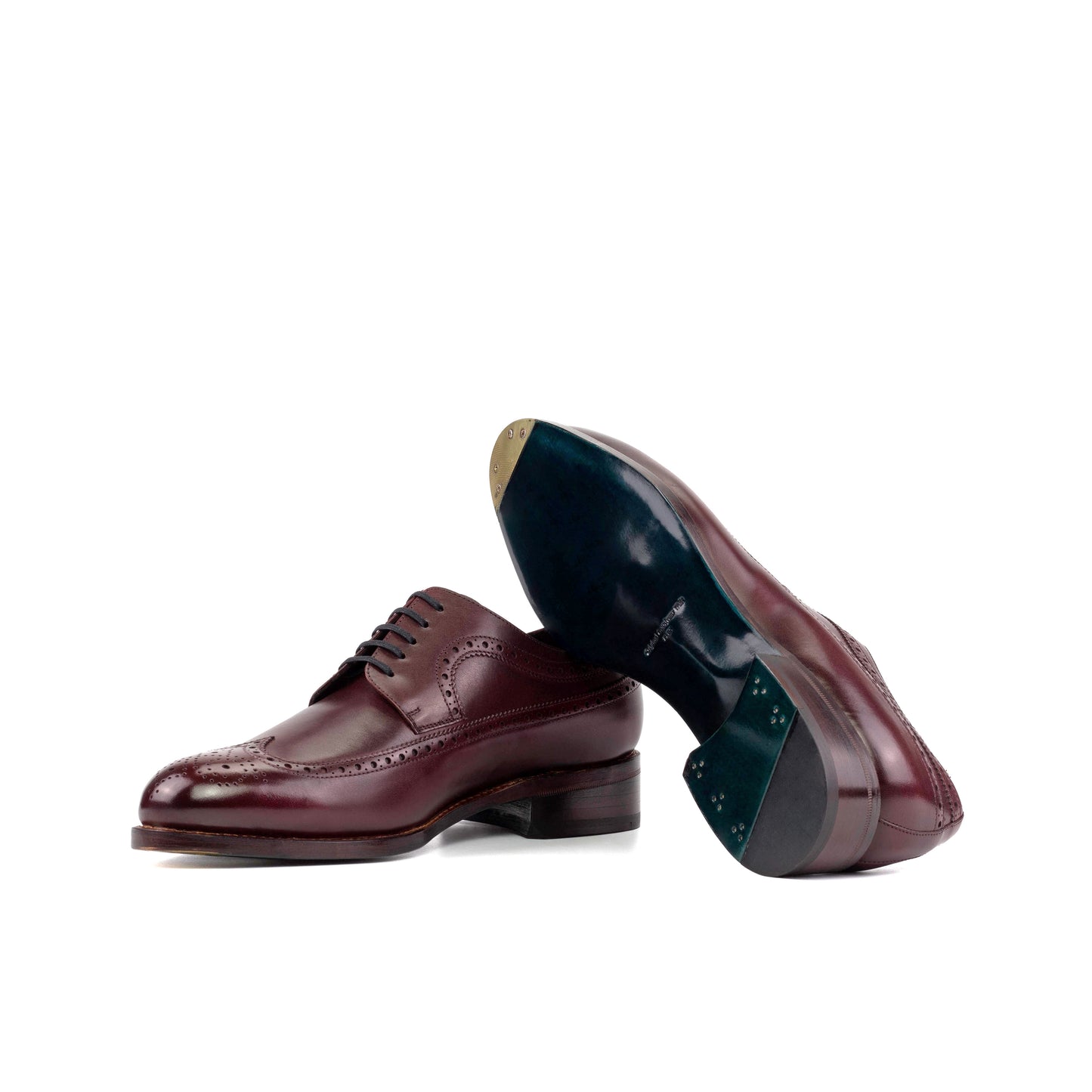 Long Wingtip Derby in Burgundy Box Calf showing turquoise leather sole with a bevelled waist