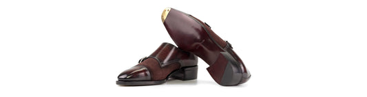 Burgundy patina and suede double monk straps showing the upper, dark red leather sole and gold toe plate.