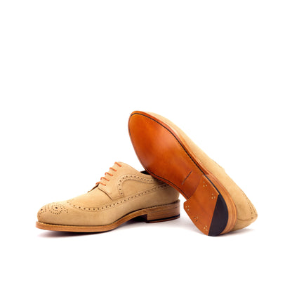Long Wingtip Derby in Camel Kid Suede showing cognac leather sole