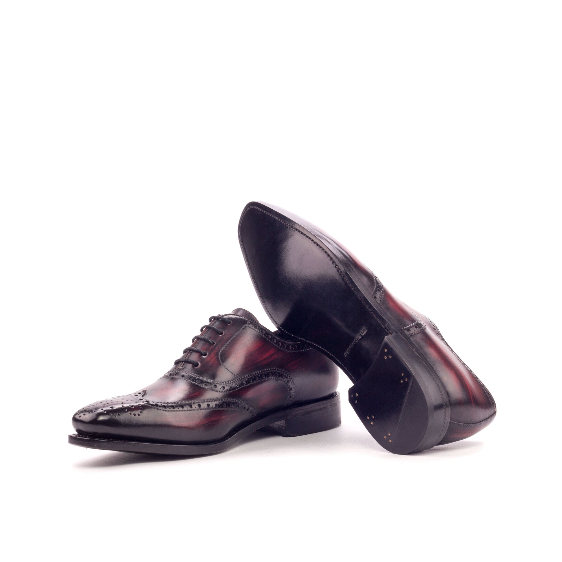 Wingtip Oxford in Burgundy Patina Box Calf and Burgundy Marble Patina Box Calf showing black leather sole
