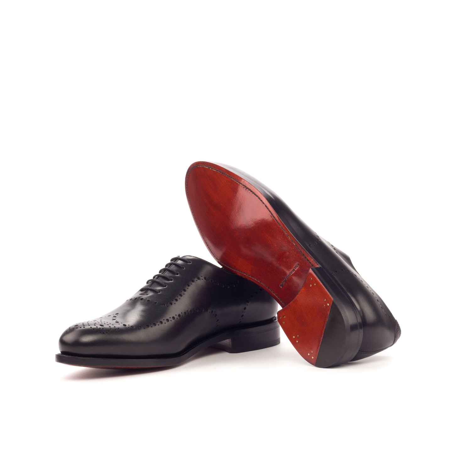 Wholecut Oxford in Black Box Calf and Black Painted Pebble-Grain Box Calf showing cognac leather sole
