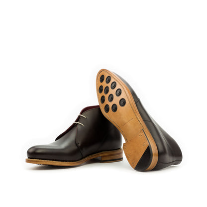 Chukka Boot in Dark Brown Box Calf showing natural leather sole with rubber button injections