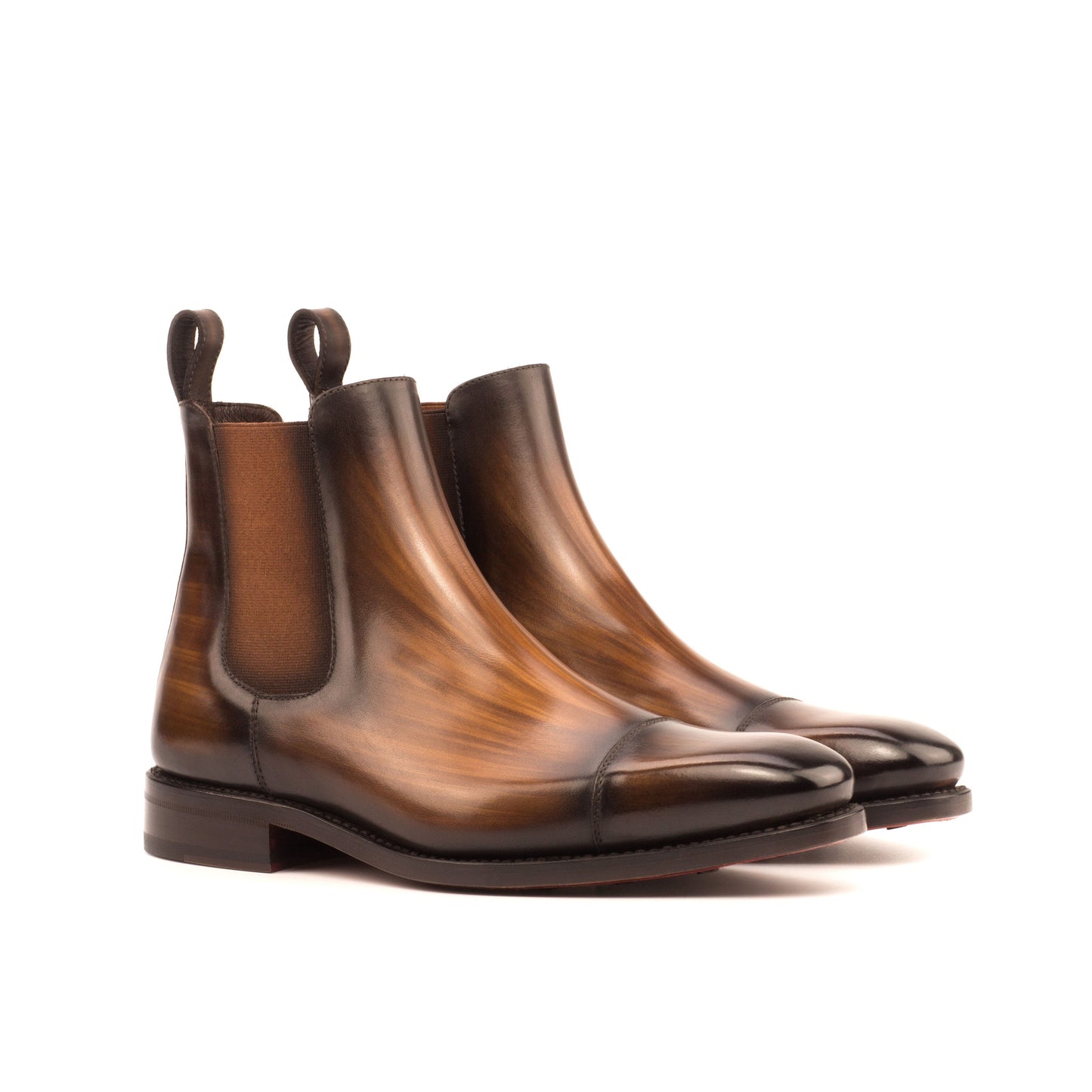 Pair of burnished medium brown box calf cap-toe Chelsea boots, front three-quarter view