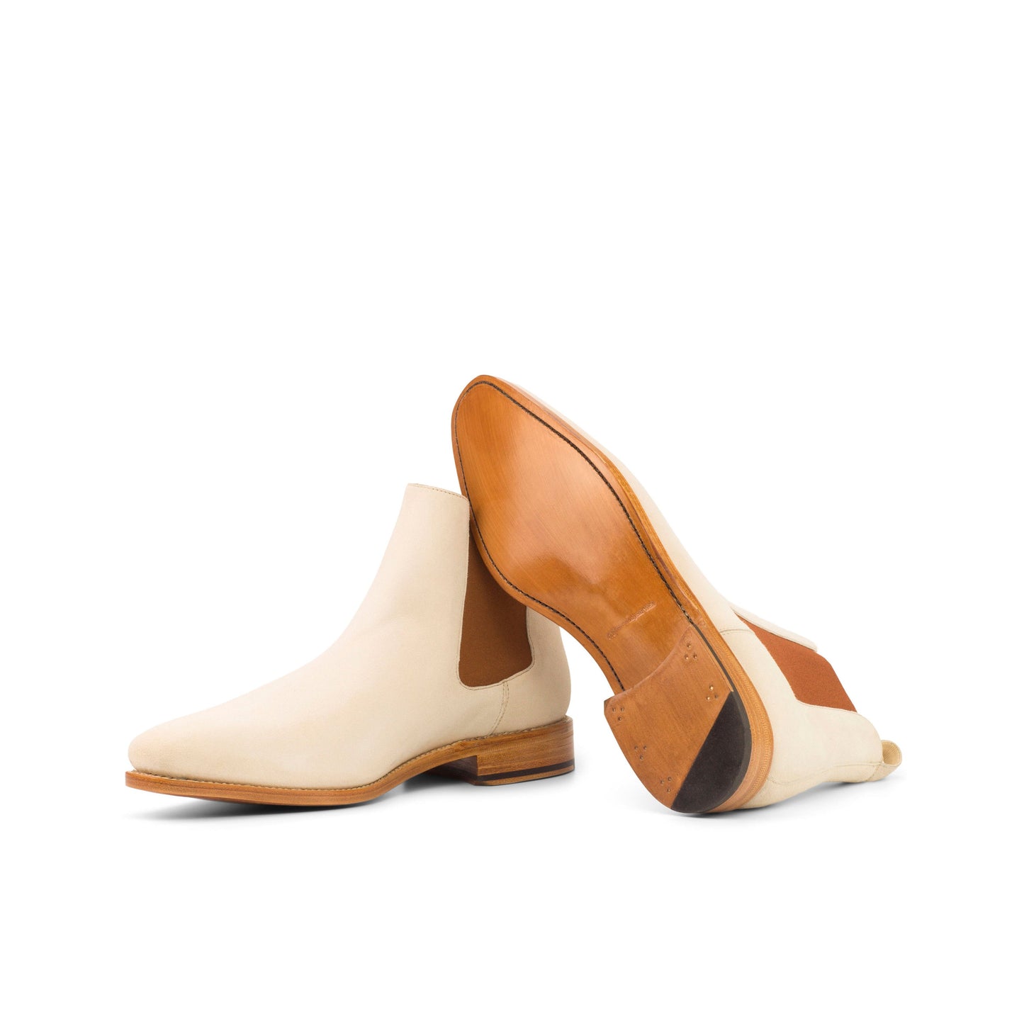 Ivory kid suede Chelsea boots showing natural leather soles