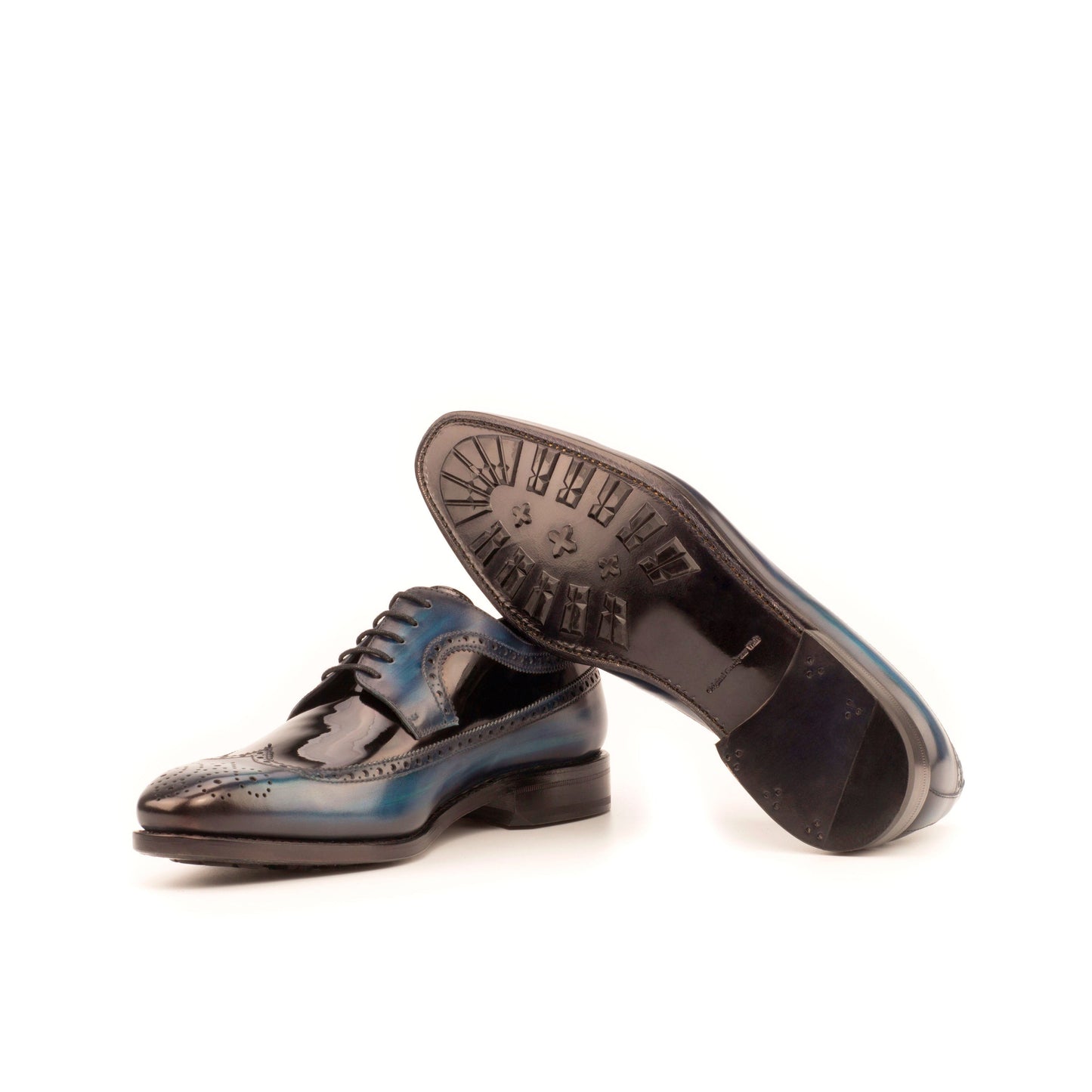 Long Wingtip Derby in Denim Patina Box Calf and Black Patent Leather showing black leather sole with mountain rubber injections