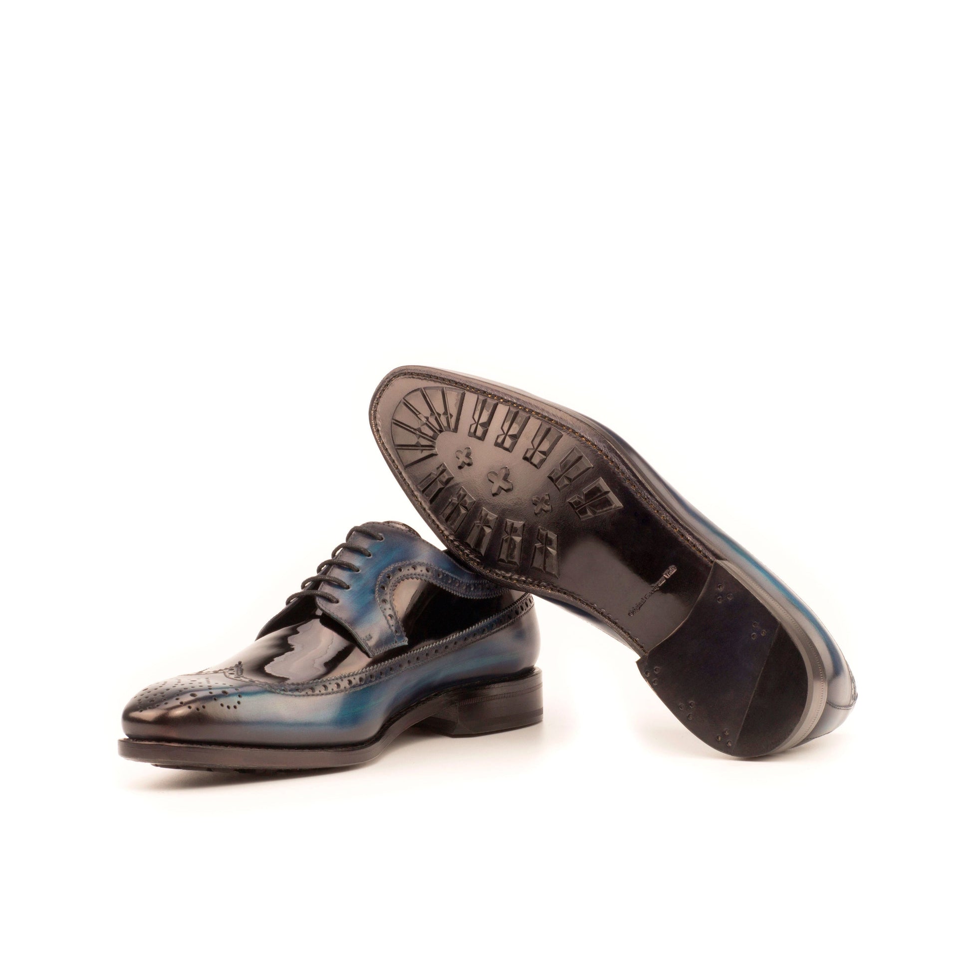Long Wingtip Derby in Denim Patina Box Calf and Black Patent Leather showing black leather sole with mountain rubber injections