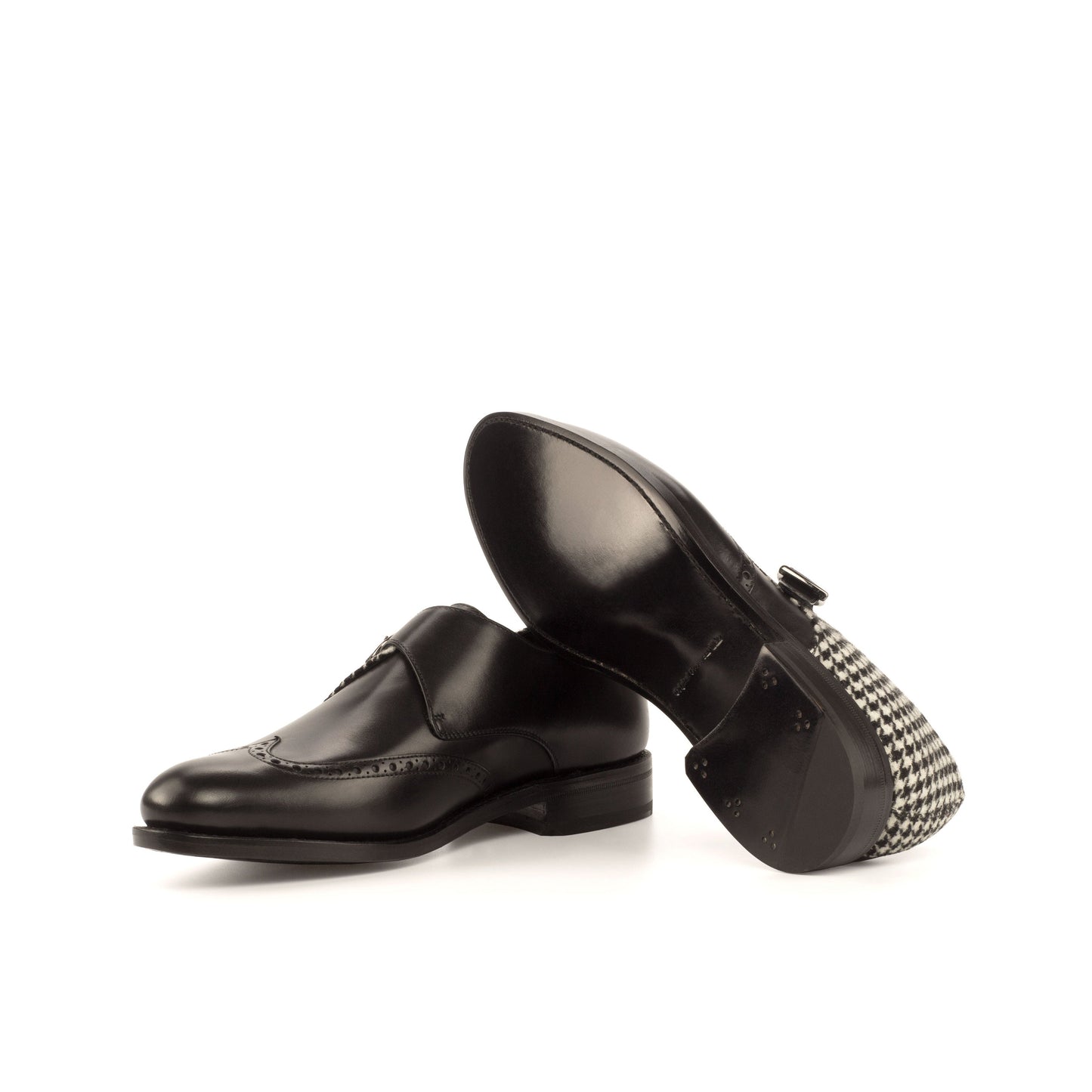 Single Monk Strap in Black Box Calf and Black and White Houndstooth Fabric showing black leather sole