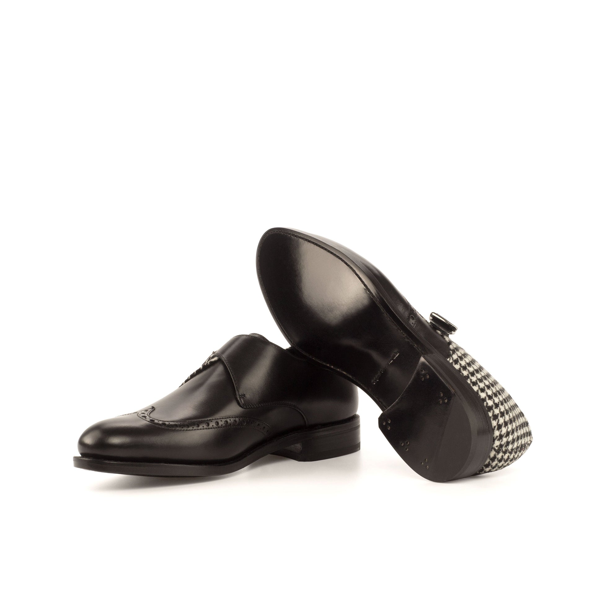 Single Monk Strap in Black Box Calf and Black and White Houndstooth Fabric showing black leather sole