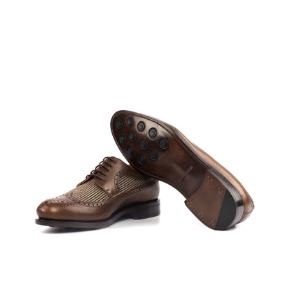 Long Wingtip Derby in Medium Brown Painted Box Calf and Brown Small-Scale Wool Tweed showing brown leather sole with rubber button injections
