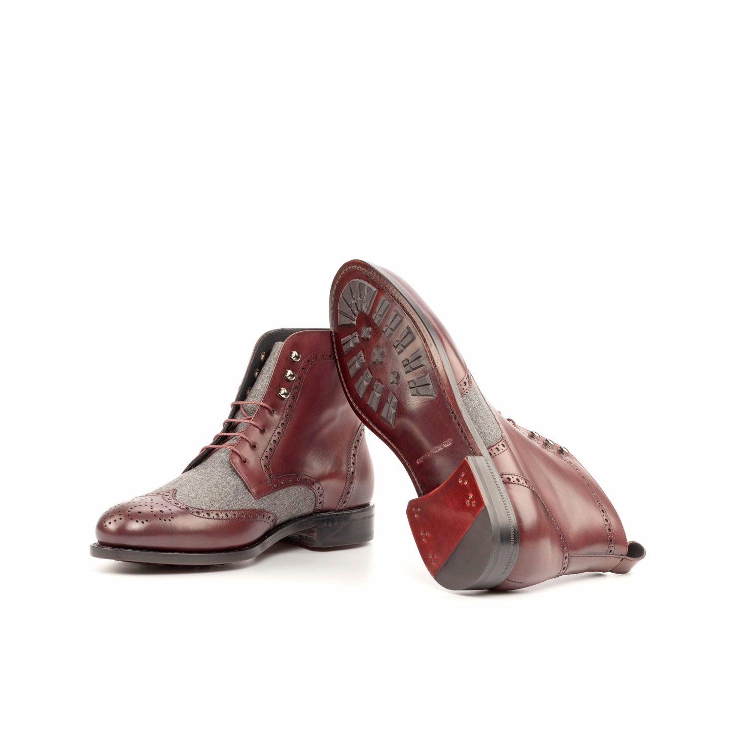 Wingtip Boot in Burgundy Painted Box Calf and Light Grey Flannel showing dark red leather sole with mountain rubber injections