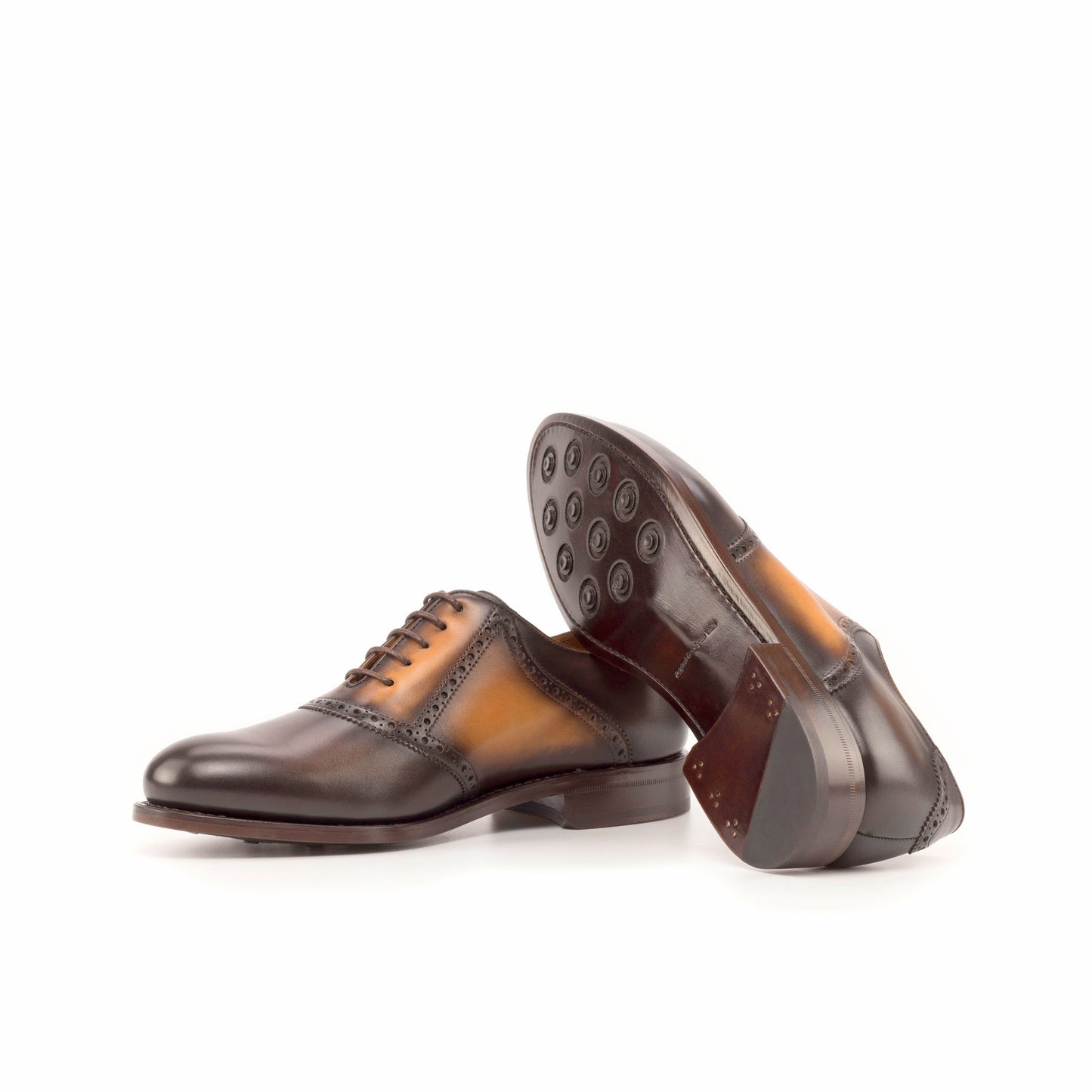 Saddle Shoe in Burnished Dark Brown Painted Box Calf and Burnished Cognac Painted Box Calf showing brown leather sole with rubber button injections