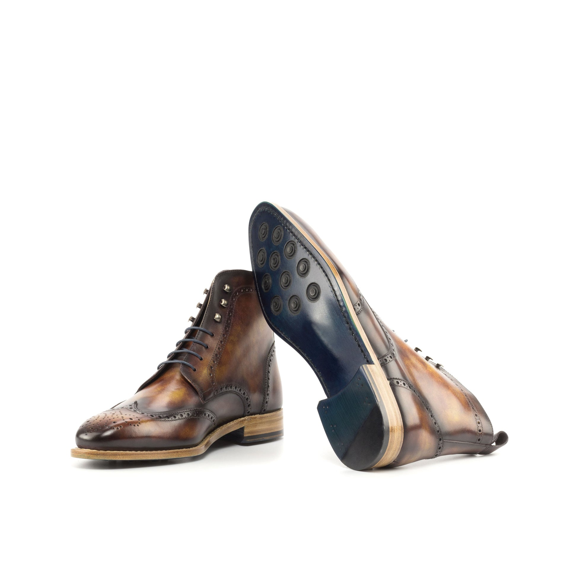 Wingtip Boot in Fire Museum Patina Box Calf showing turquoise leather sole with rubber button injections