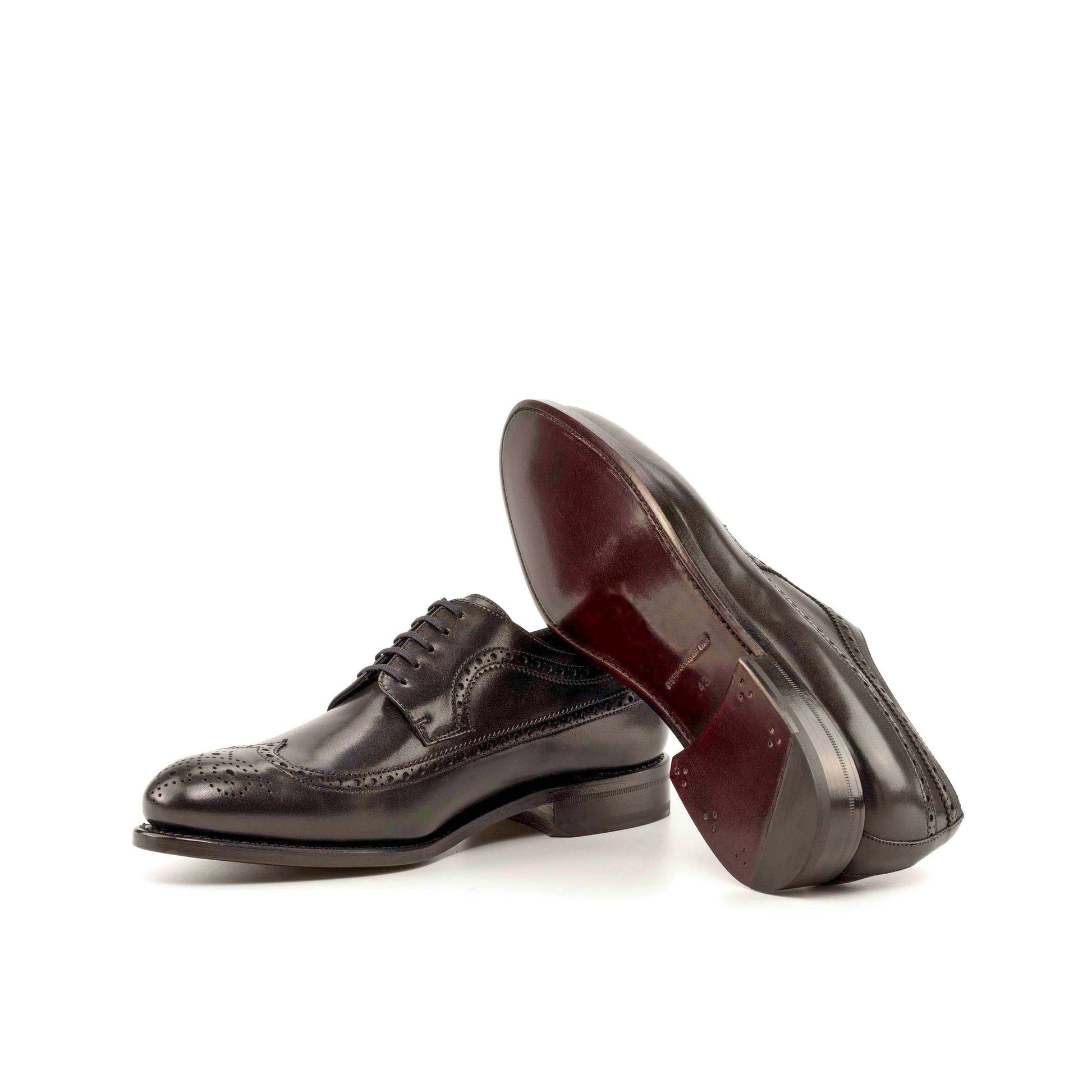 Long Wingtip Derby in Black Box Calf showing dark red leather sole
