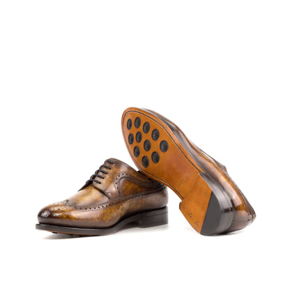 Long Wingtip Derby in Cognac Marble Patina Box Calf showing cognac leather sole with rubber button injections