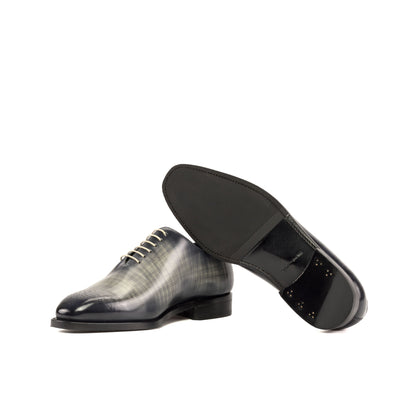 Wholecut Oxford in Grey Patina Box Calf showing black leather and rubber combination sole