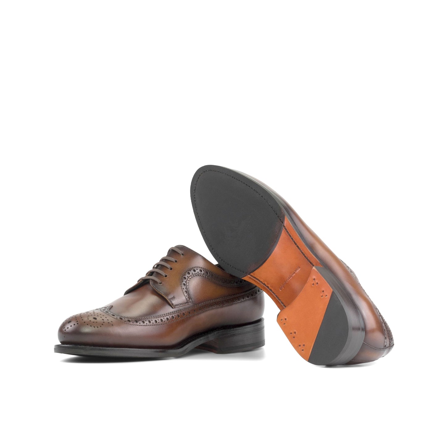 Long Wingtip Derby in Burnished Dark Brown Box Calf showing orange leather sole