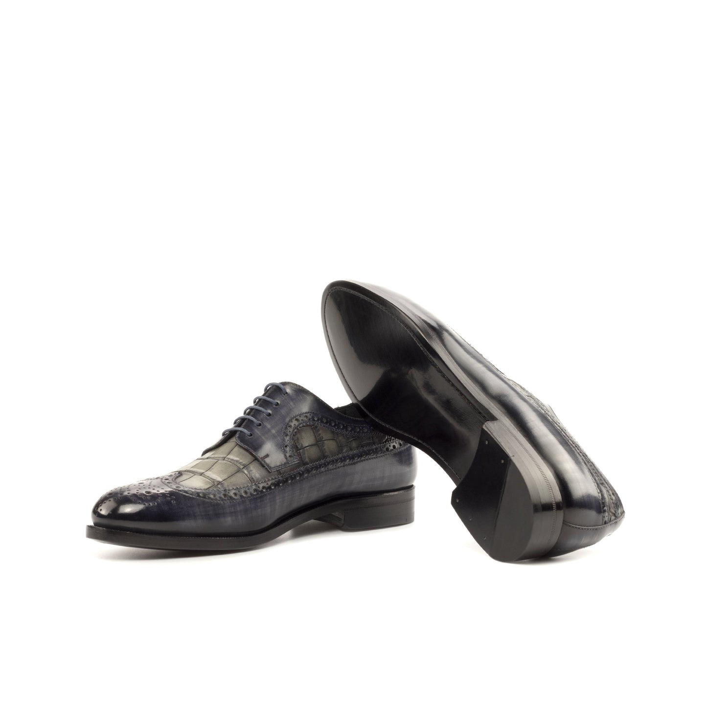 Long Wingtip Derby in Grey Patina Box Calf and Grey Painted Croco-Embossed Box Calf showing black leather sole