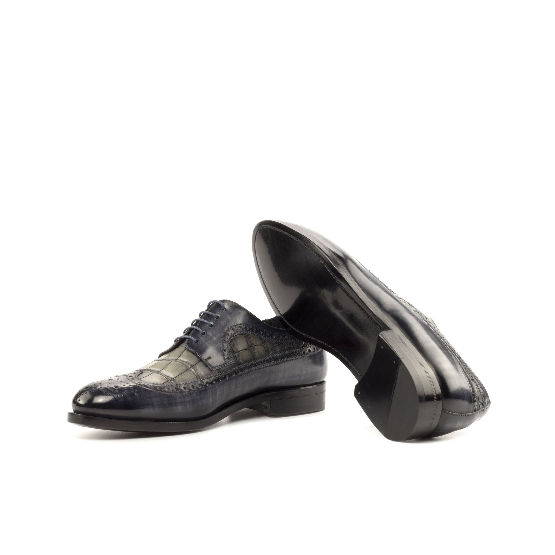 Long Wingtip Derby in Grey Patina Box Calf and Grey Painted Croco-Embossed Box Calf showing black leather sole