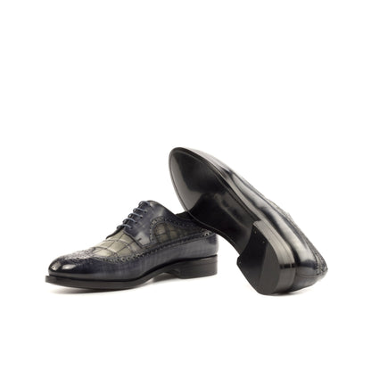 Long Wingtip Derby in Grey Patina Box Calf and Grey Painted Croco-Embossed Box Calf showing black leather sole