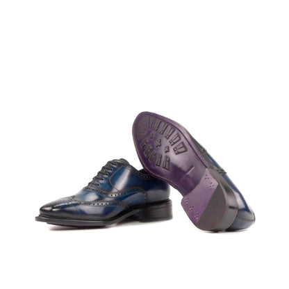 Wingtip Oxford in Denim Patina Box Calf showing lilac leather sole