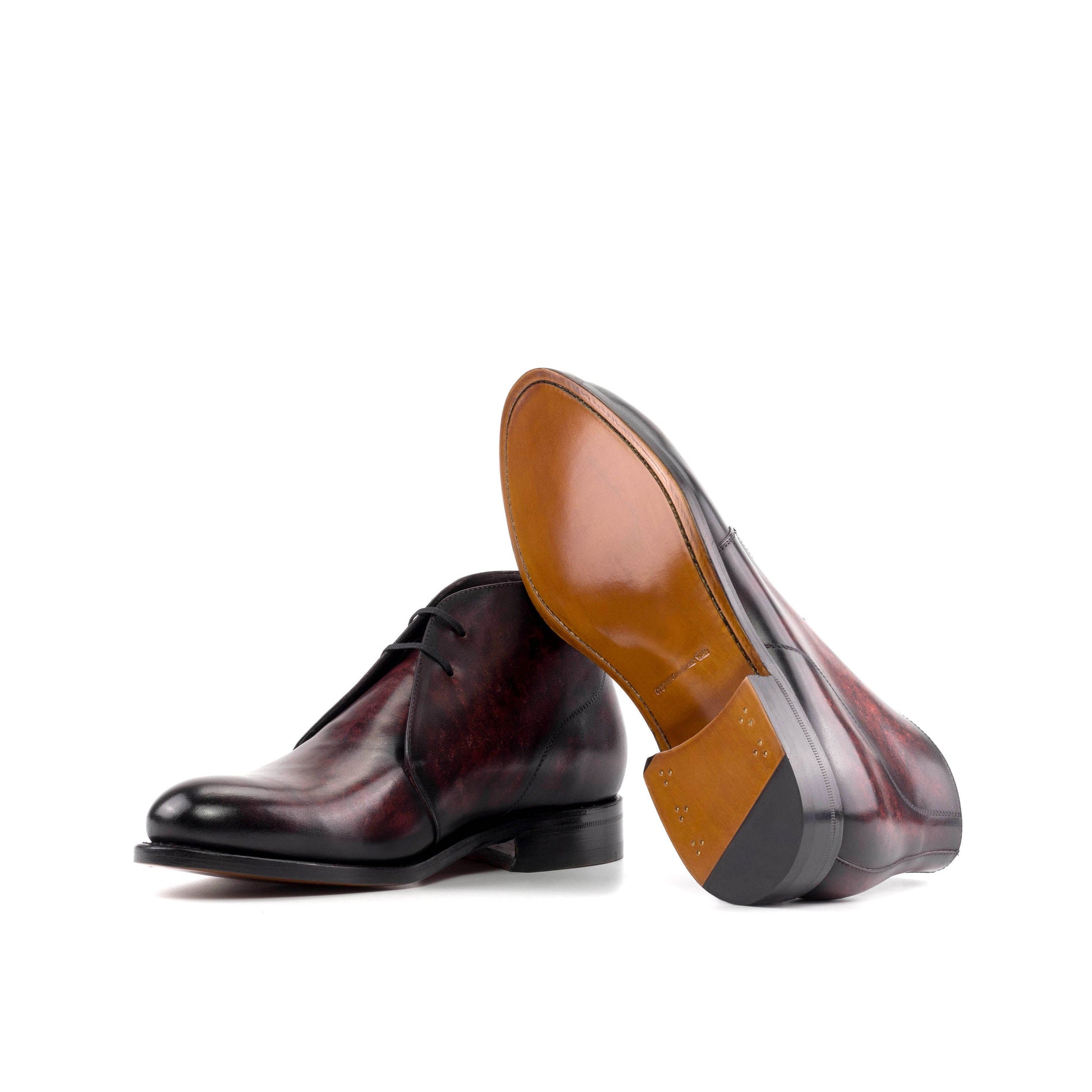 Burgundy Marble Patina Box Calf Chukka boots showing cognac leather sole
