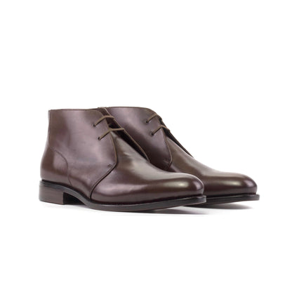 Pair of dark brown box calf Chukka boots with brown round laces, front three-quarter view