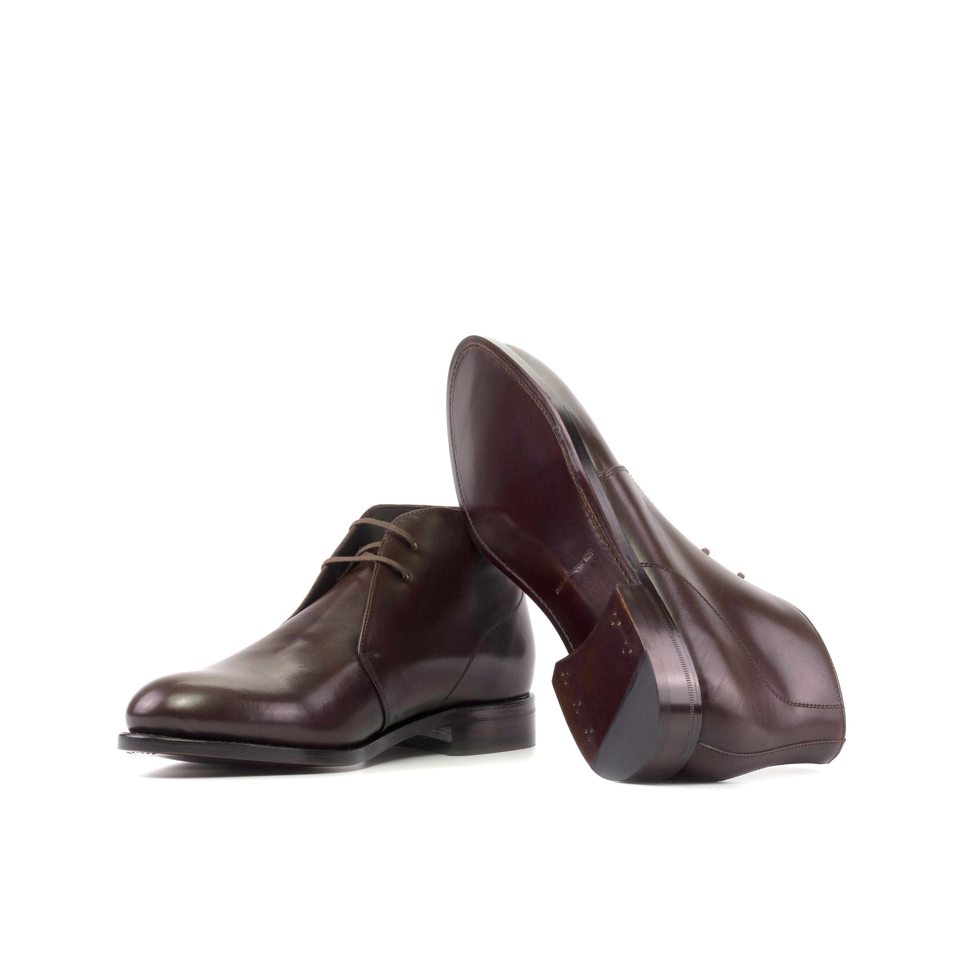 Dark brown box calf Chukka boots showing brown leather soles