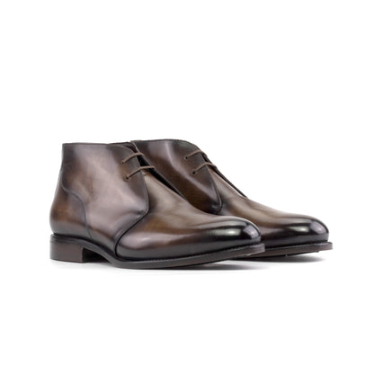 Pair of brown patina box calf Chukka boots with brown round laces, front three-quarter view