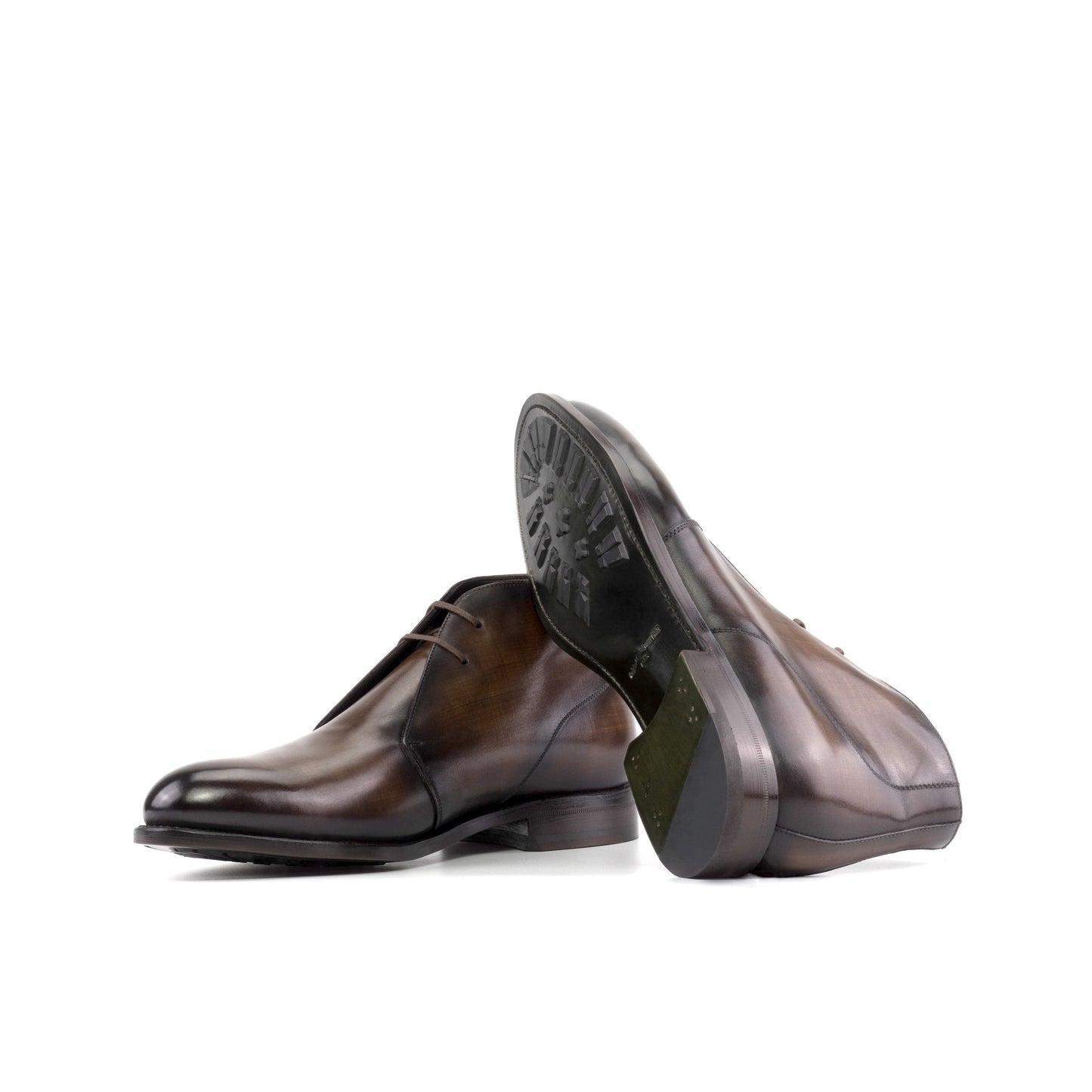 Brown patina box calf Chukka boots showing forest green leather soles with mountain rubber injections