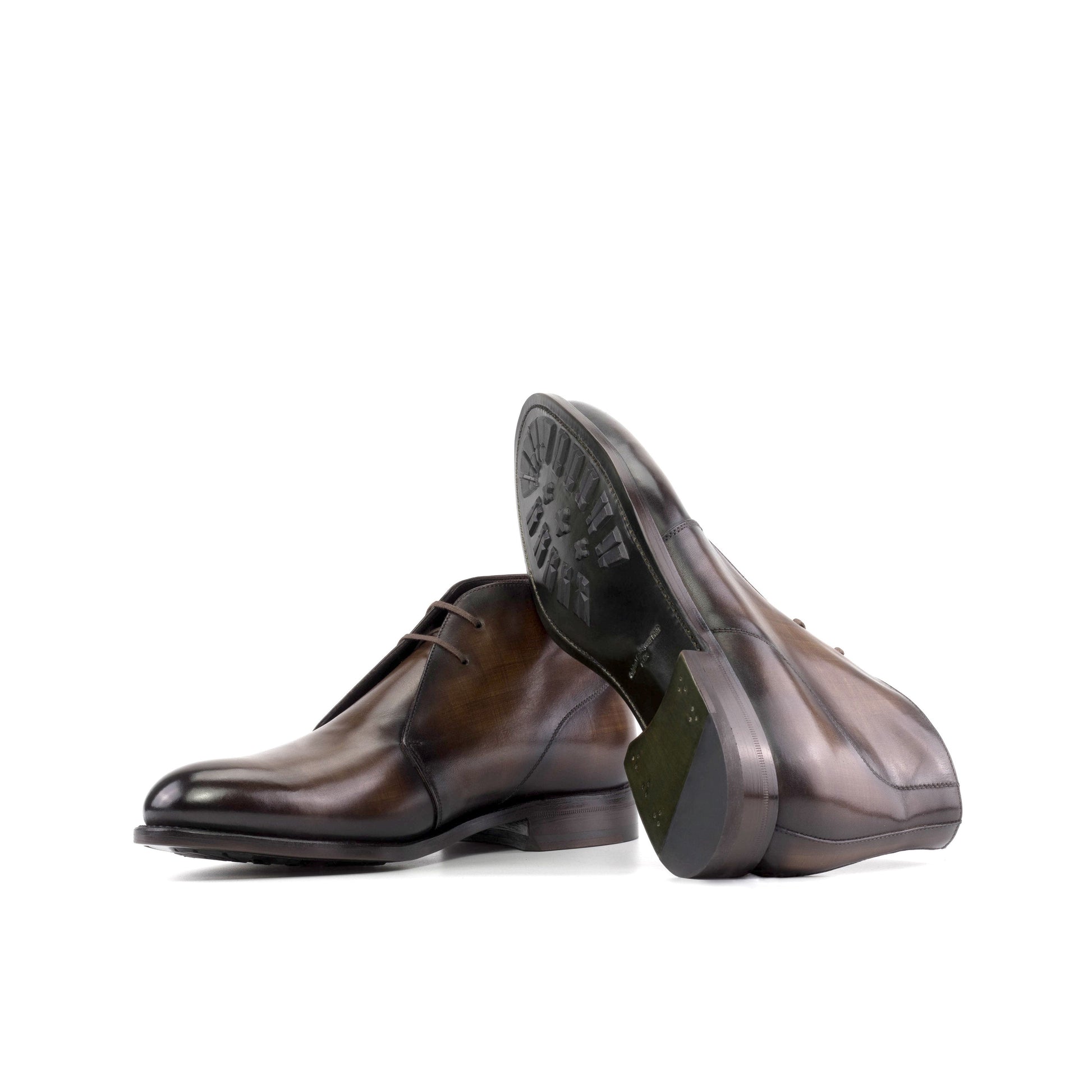 Brown patina box calf Chukka boots showing forest green leather soles with mountain rubber injections