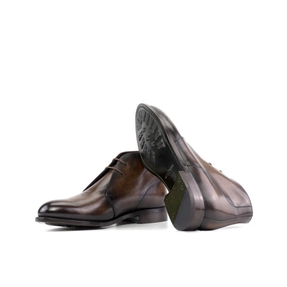 Brown patina box calf Chukka boots showing forest green leather soles with mountain rubber injections