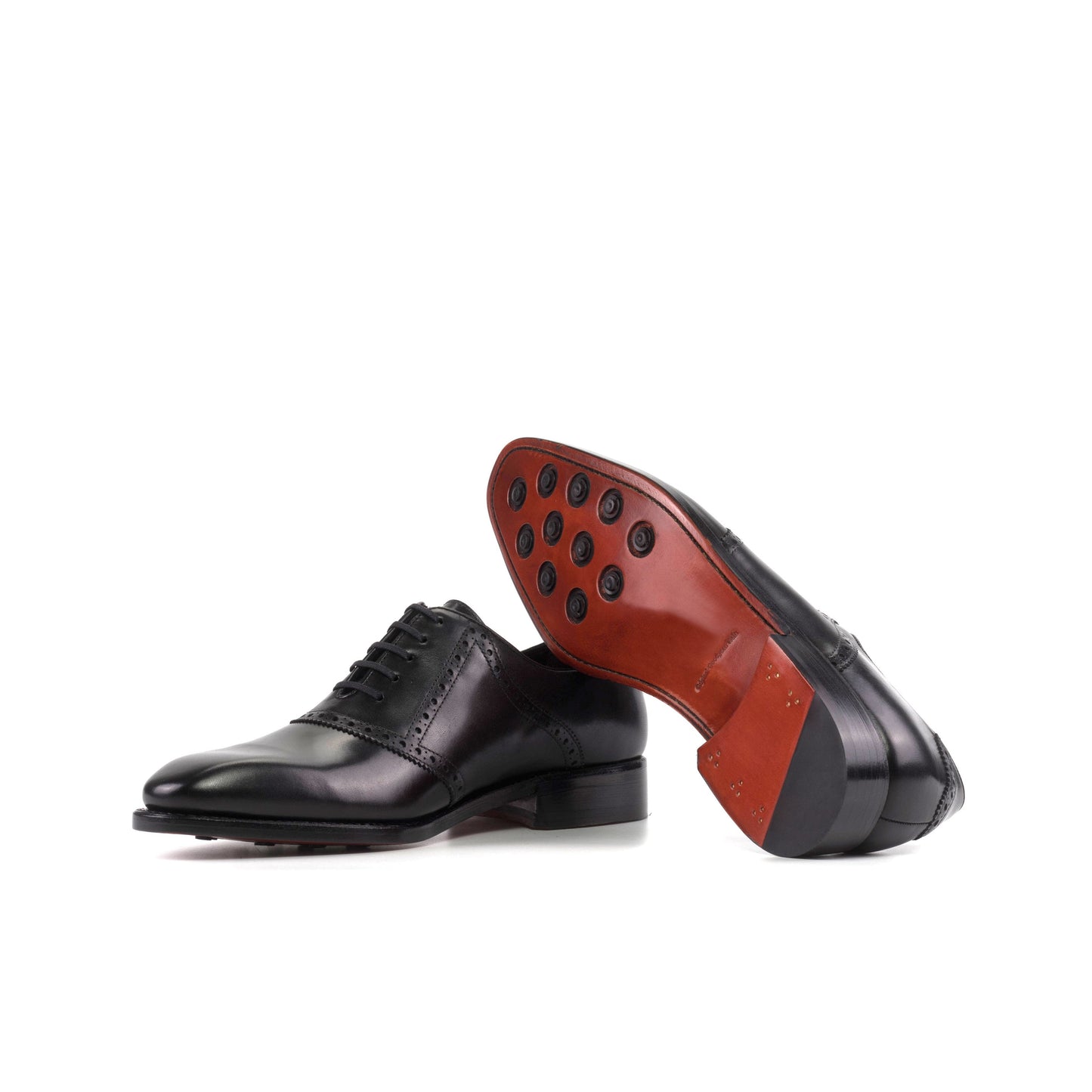 Saddle Shoe in Black Box Calf showing red leather sole with rubber button injections