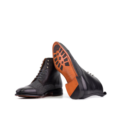 Jumper Boot in Black Painted Box Calf and Dark Grey Flannel showing orange leather sole with mountain rubber injections
