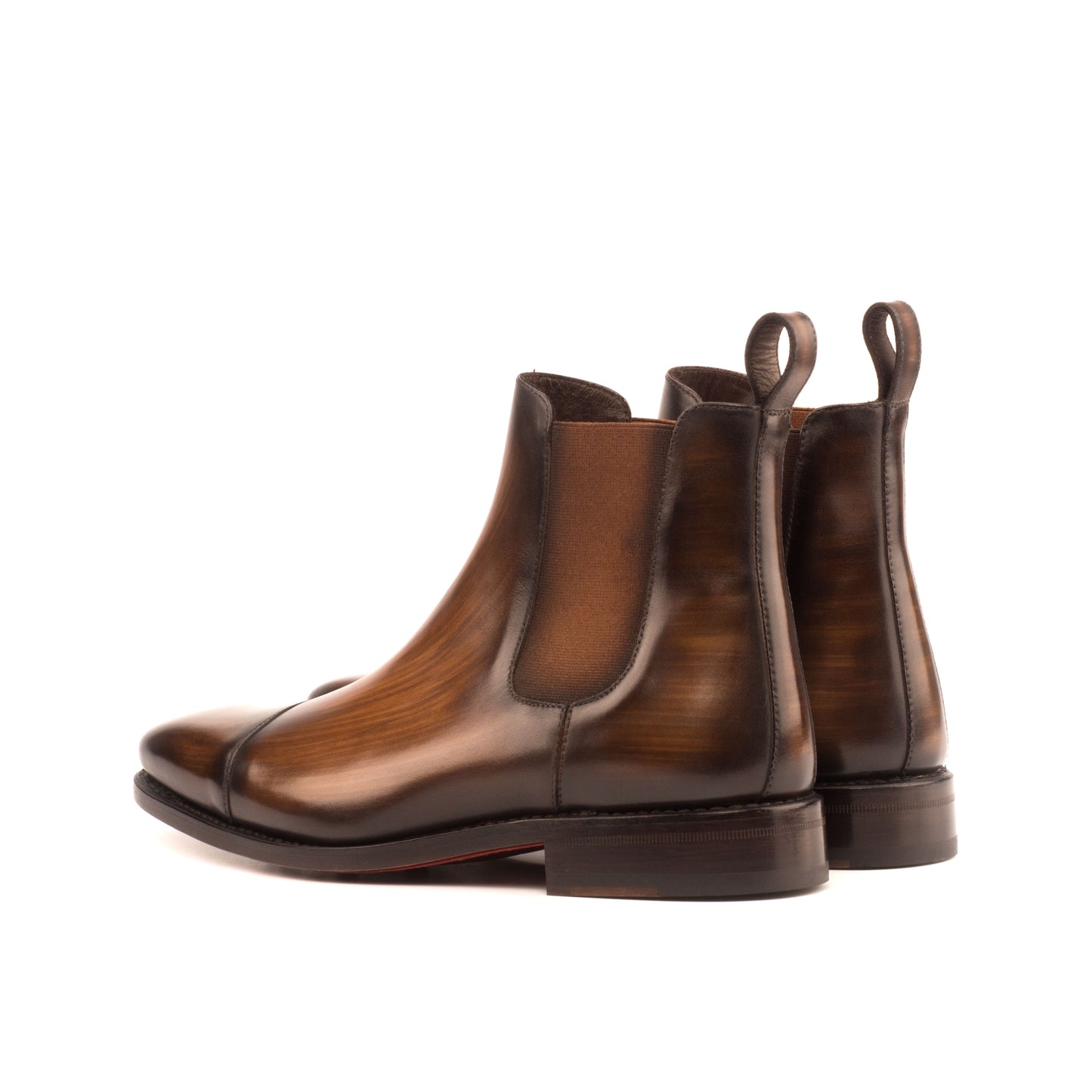 Burnished medium brown box calf Chelsea boots with cognac elastic gussets, rear three-quarter view